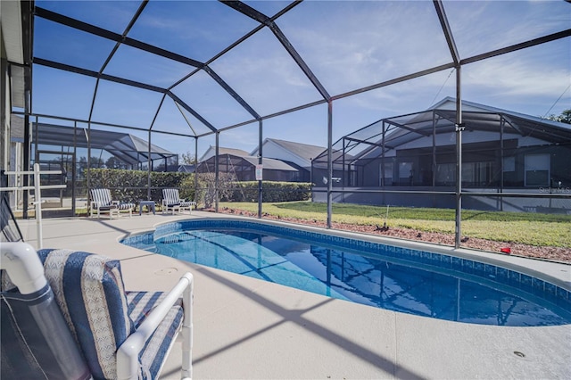 view of pool with a patio area, a yard, and glass enclosure