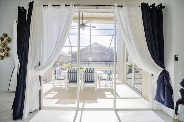 entryway featuring a wealth of natural light, tile patterned floors, and ceiling fan