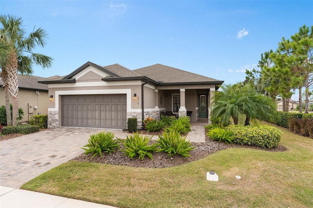 view of front facade with a front yard and a garage