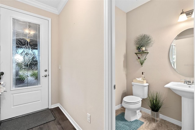 bathroom featuring crown molding, wood-type flooring, and toilet