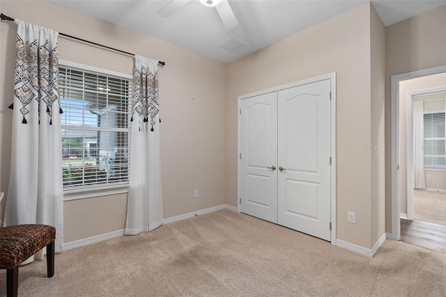 carpeted bedroom with a closet and ceiling fan