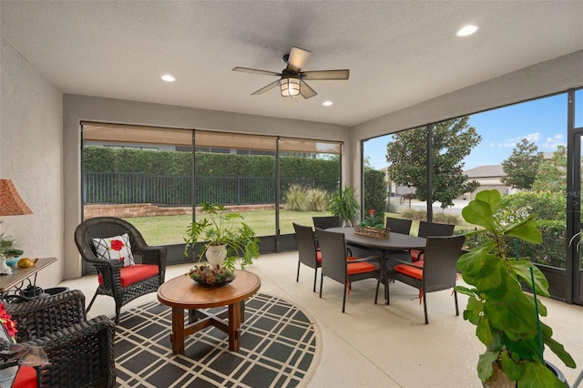 sunroom featuring ceiling fan