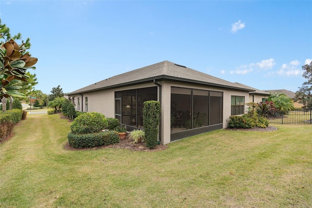 view of home's exterior with a lawn and a sunroom