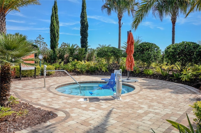 view of swimming pool with an in ground hot tub