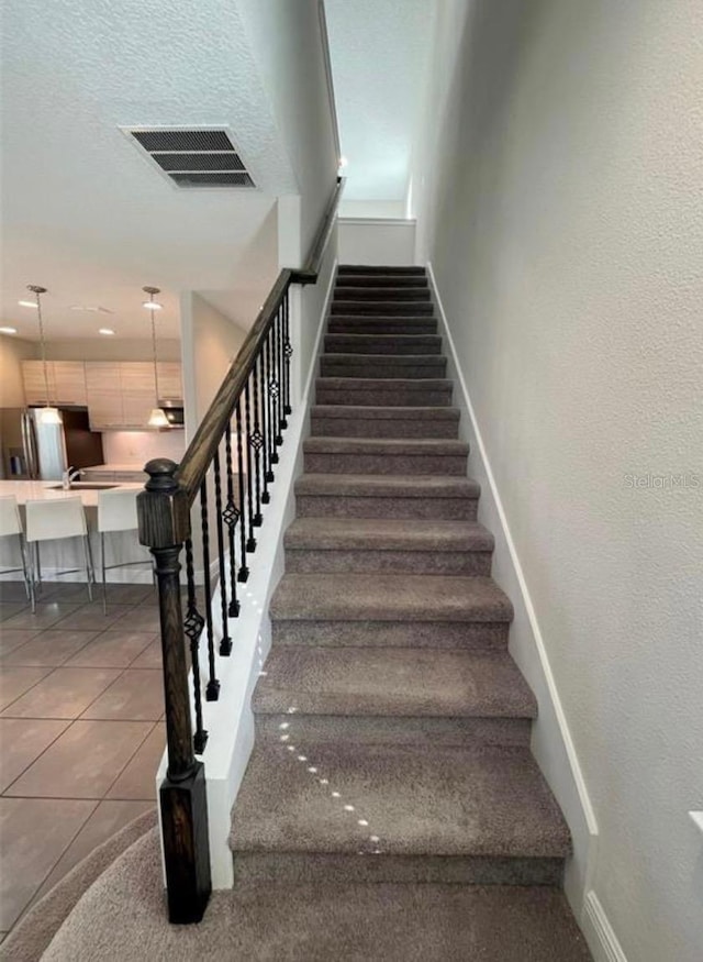 staircase with tile patterned flooring