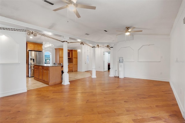 unfurnished living room with ornate columns, ceiling fan, light hardwood / wood-style flooring, and ornamental molding