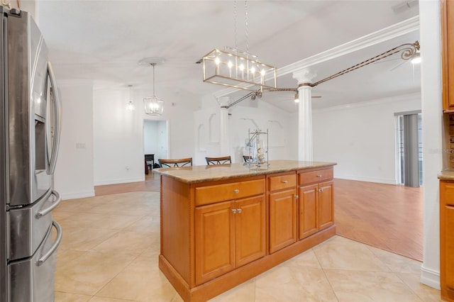 kitchen featuring stainless steel fridge, crown molding, pendant lighting, and light tile patterned flooring