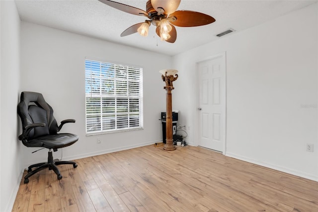 home office featuring light hardwood / wood-style flooring and ceiling fan