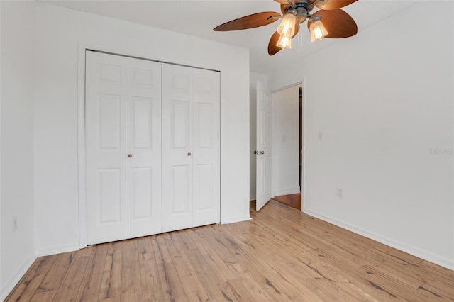 unfurnished bedroom with ceiling fan, light hardwood / wood-style flooring, and a closet