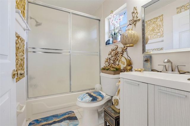 full bathroom featuring tile patterned flooring, vanity, toilet, and shower / bath combination with glass door