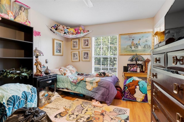 bedroom featuring ceiling fan and light hardwood / wood-style floors