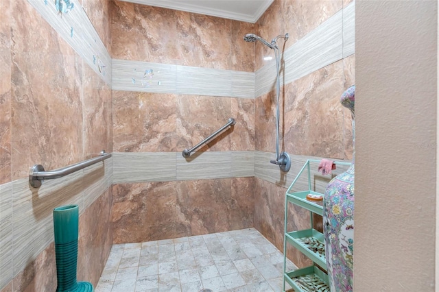 bathroom featuring tiled shower and crown molding