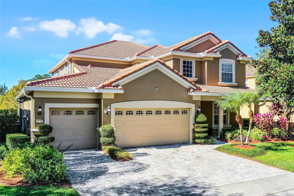 mediterranean / spanish-style home with a garage