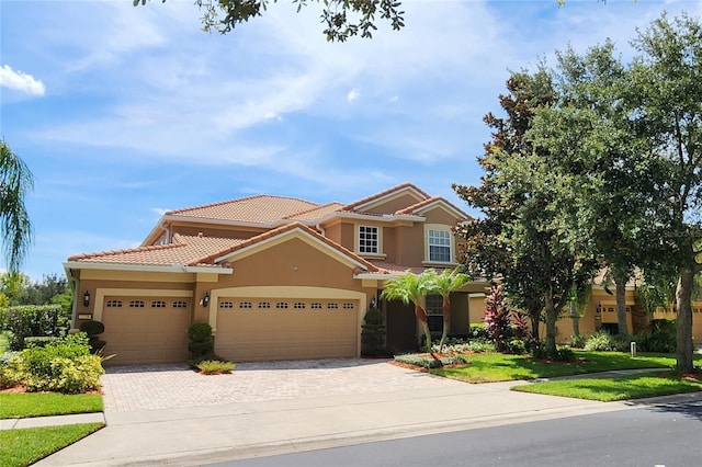 view of front of home featuring a garage and a front lawn