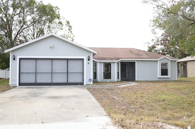 ranch-style house featuring a garage and a front yard