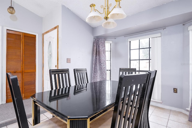 tiled dining area featuring a textured ceiling, a notable chandelier, and vaulted ceiling