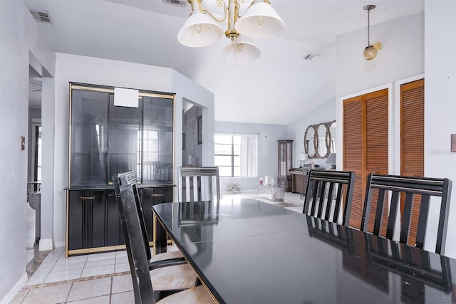 dining area featuring vaulted ceiling, light tile patterned flooring, a textured ceiling, and a notable chandelier