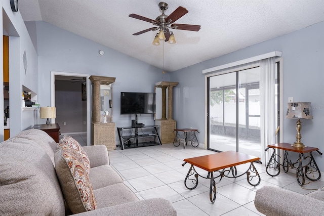 tiled living room featuring a textured ceiling, ceiling fan, lofted ceiling, and decorative columns