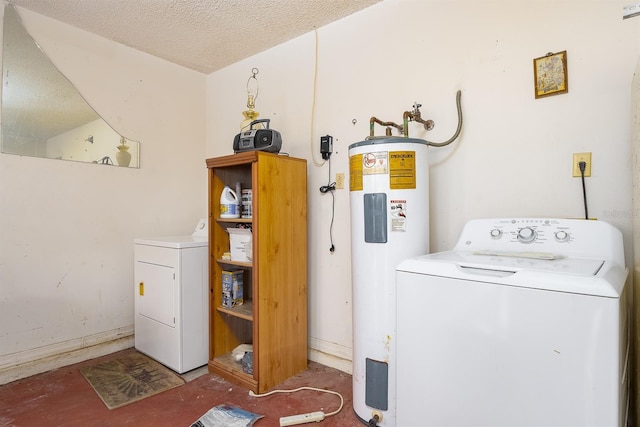 clothes washing area featuring washer and clothes dryer, water heater, and a textured ceiling