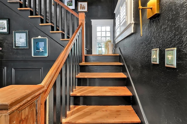 staircase featuring a textured wall