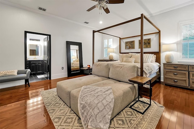 bedroom featuring visible vents, dark wood-type flooring, and ornamental molding