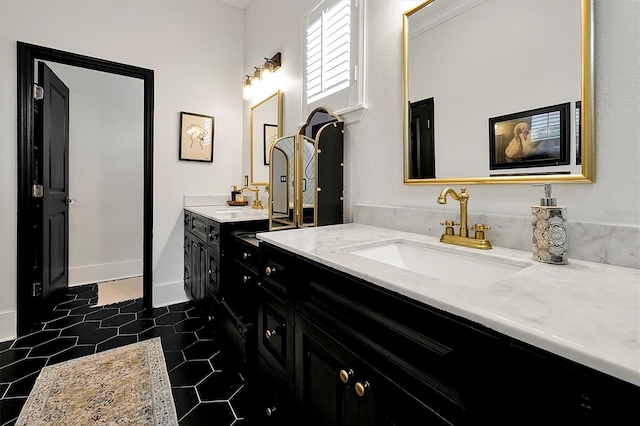 full bathroom with tile patterned floors, two vanities, and a sink