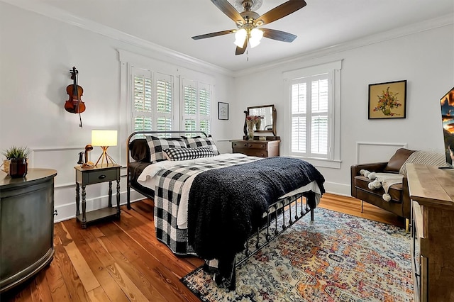 bedroom with wood finished floors, ceiling fan, and ornamental molding