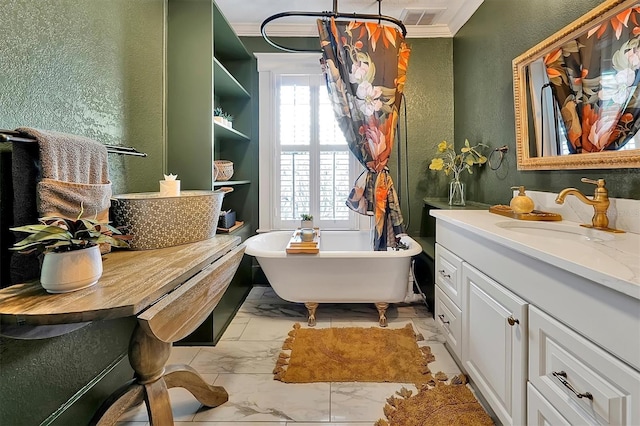 bathroom with visible vents, marble finish floor, a soaking tub, vanity, and a textured wall