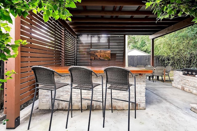 view of patio / terrace with a pergola and fence