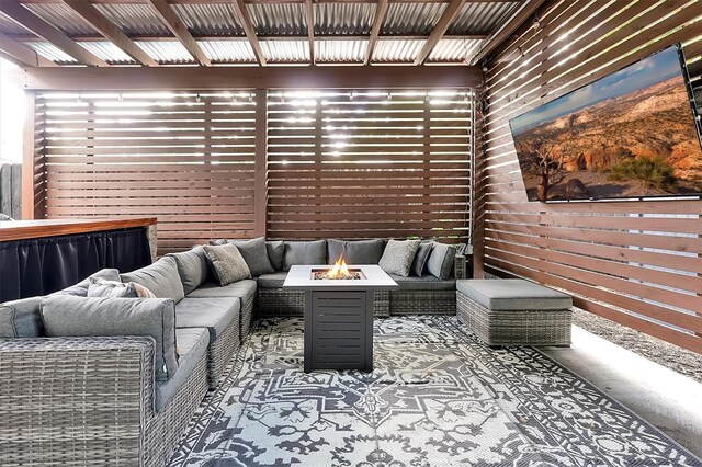 wooden terrace featuring an outdoor living space with a fire pit