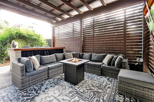 view of patio featuring an outdoor living space with a fire pit