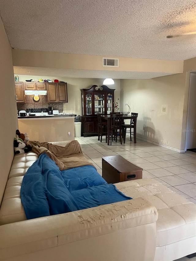 living room with light tile patterned floors and a textured ceiling