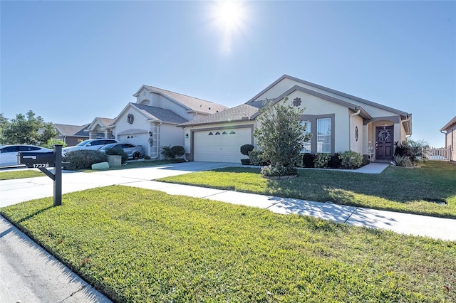 ranch-style house featuring a front yard and a garage