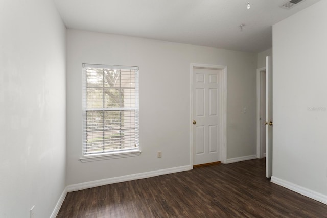 empty room with dark wood-type flooring