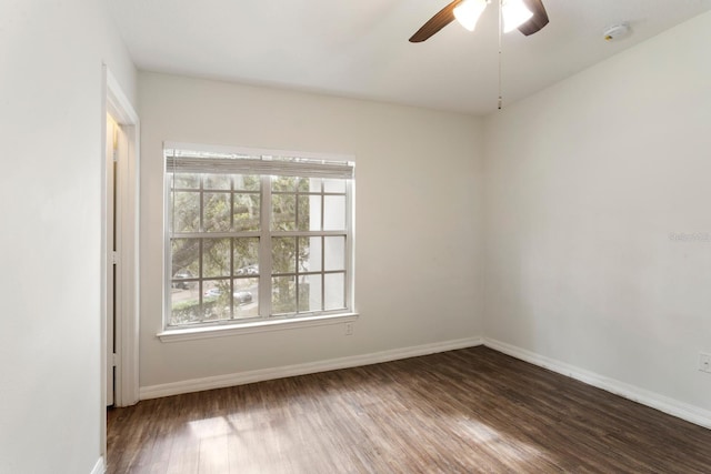 unfurnished room with ceiling fan and dark hardwood / wood-style flooring