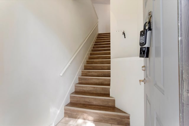 stairway featuring tile patterned floors