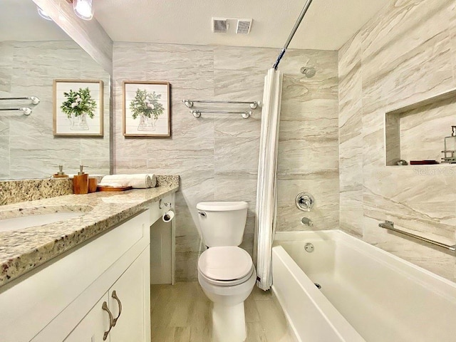 full bathroom with vanity, toilet, shower / bath combo with shower curtain, and tile walls