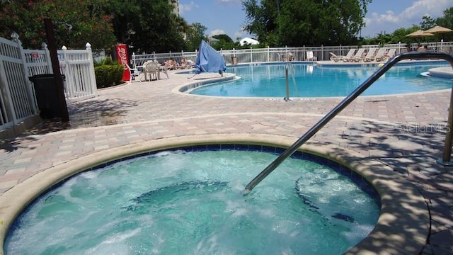 view of pool featuring a patio area and a hot tub