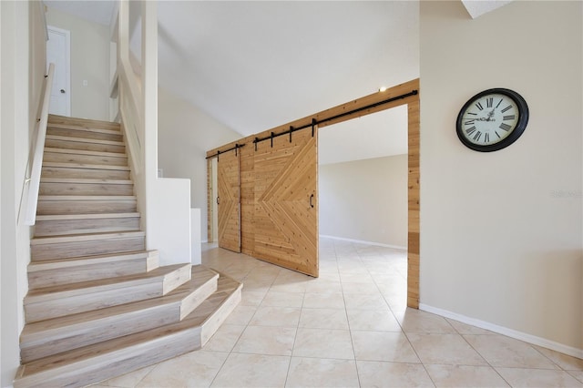 2981 Viscount Cir, Kissimmee, FL 34747 - staircase with a barn door, lofted ceiling, and tile patterned floors