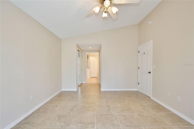 spare room with light tile patterned flooring, ceiling fan, lofted ceiling, and a textured ceiling