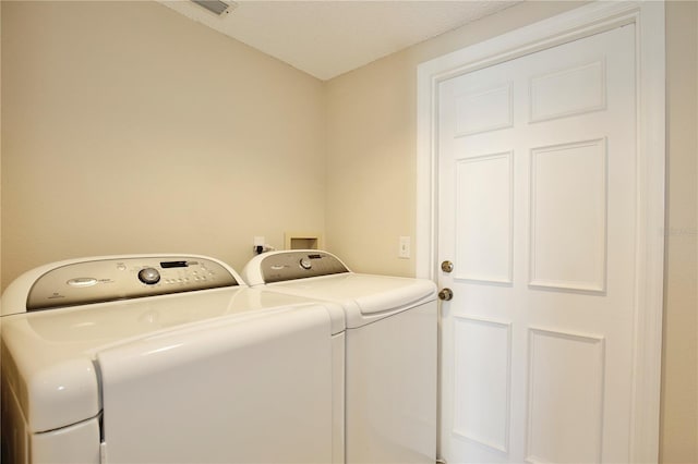 washroom featuring independent washer and dryer