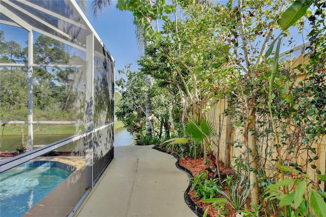 view of pool featuring a water view and a lanai