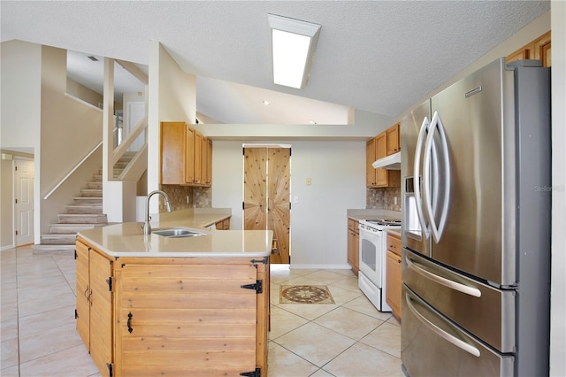 kitchen with light tile patterned flooring, a sink, vaulted ceiling, stainless steel fridge, and white electric range oven