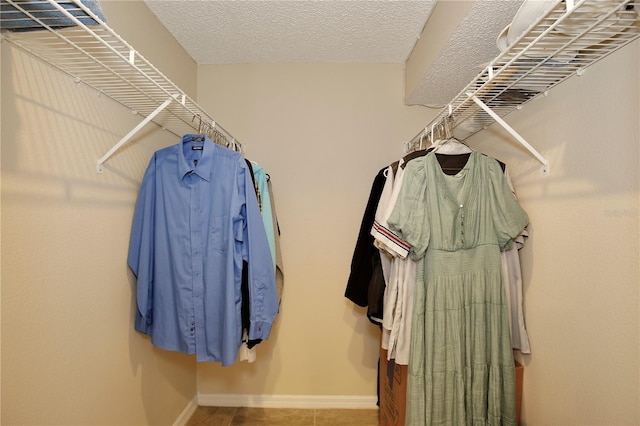 walk in closet with tile patterned floors