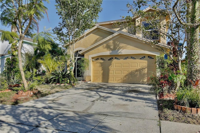 2981 Viscount Cir, Kissimmee, FL 34747 - view of front of home featuring stucco siding, a garage, and concrete driveway