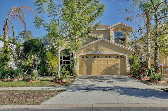 2981 Viscount Cir, Kissimmee, FL 34747 - view of front facade with a garage, stucco siding, and concrete driveway