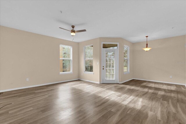 unfurnished room with hardwood / wood-style floors and ceiling fan