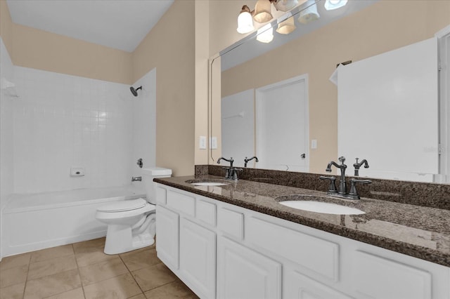 full bathroom with tile patterned flooring, vanity, tiled shower / bath combo, and toilet