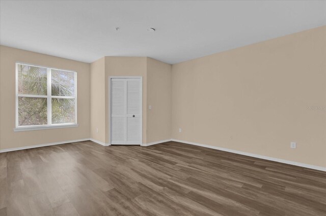 unfurnished room with hardwood / wood-style flooring