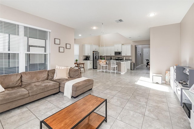 living room featuring light tile patterned flooring and lofted ceiling